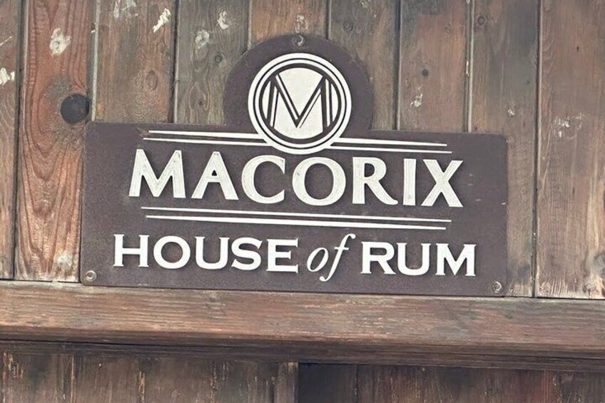 A wooden sign with the text 'MACORIX HOUSE of RUM'. 1