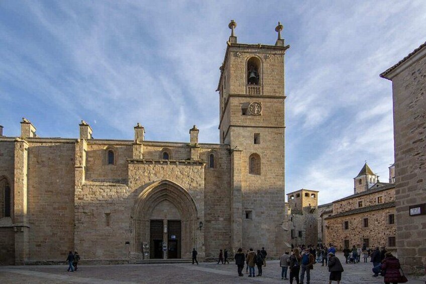 A historic stone building with a prominent tower and arched entrance. 3