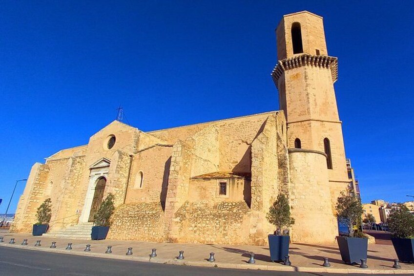 A historic stone church with a bell tower, arched windows, and a prominent entrance. 3