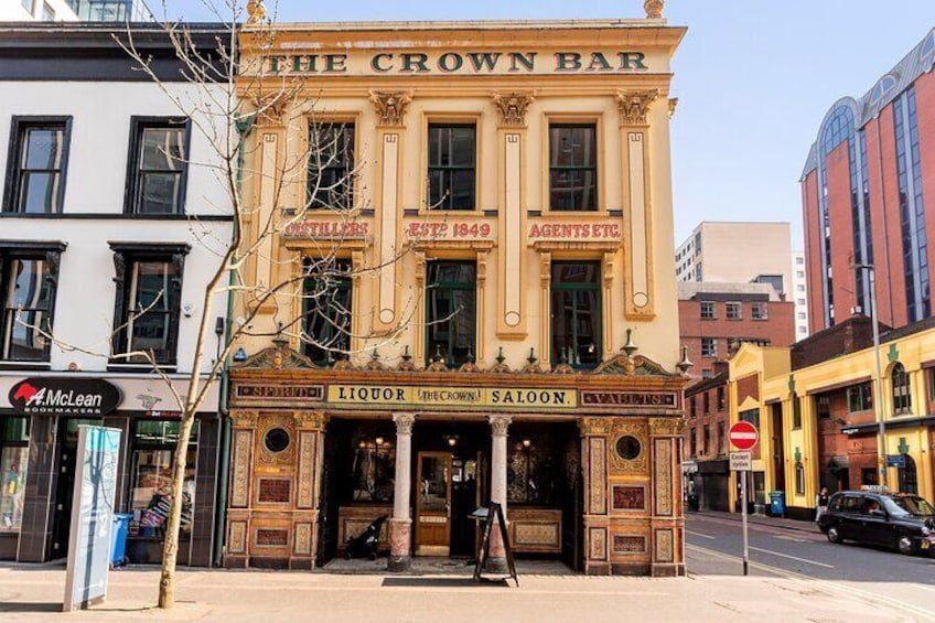 The Crown Bar, a historic building with ornate architecture, established in 1849, and a sign for McLean Liquor. 2