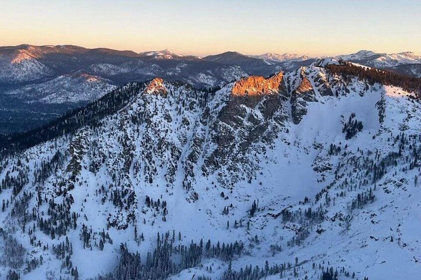 A snow-covered mountain range with a forested valley. 4