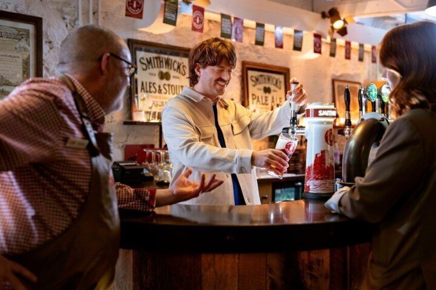 A bar with a beer tap and a sign that reads 'Smithwick's Ales & Stout.' 5