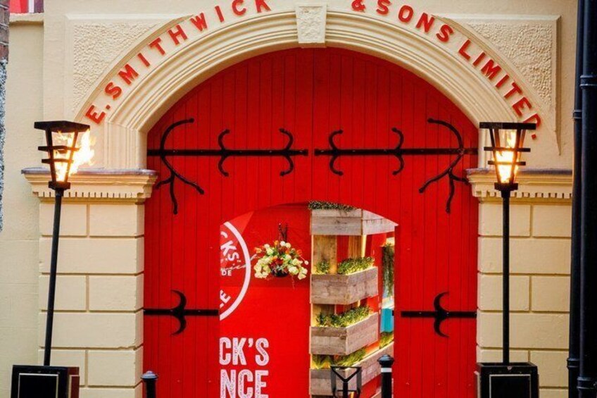 A red storefront with the sign "E. Smithwick & Sons Limited" and "CK's NCE" on the door. 1