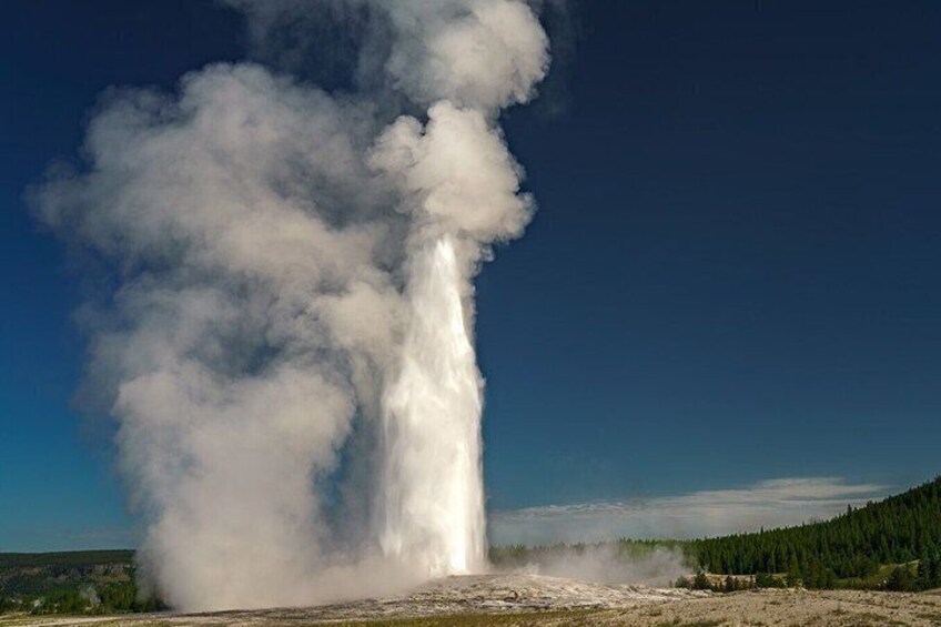 A geyser erupting with steam and water. 1