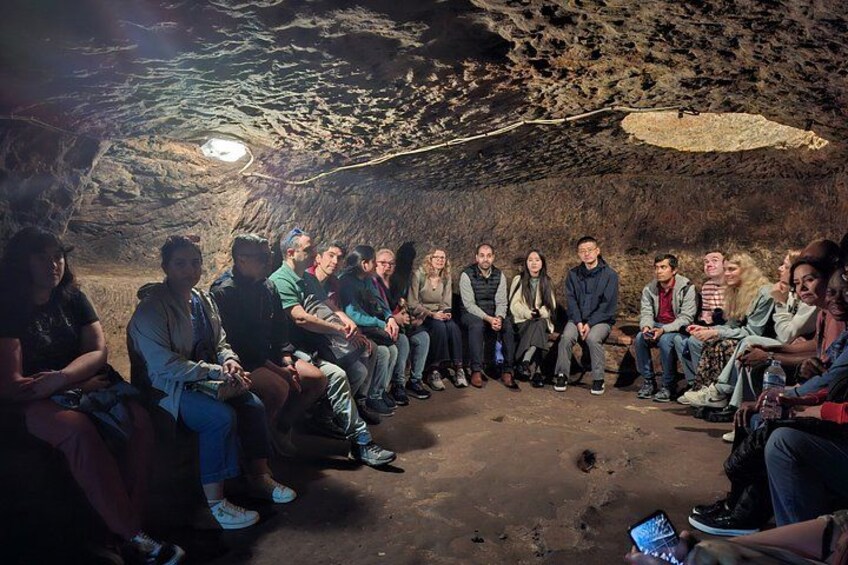 A group of people sitting in a cave. 2
