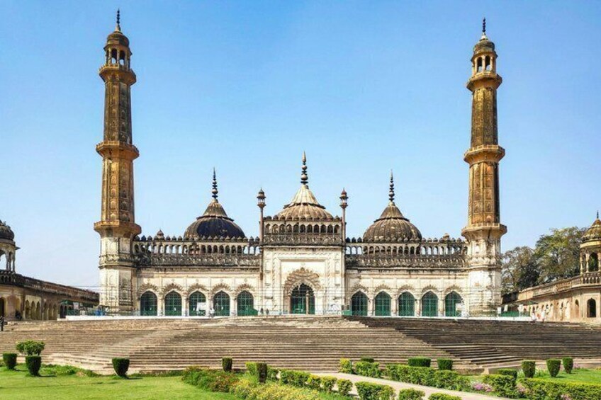 A large mosque with two minarets, domes, and a courtyard. 1