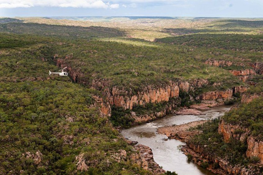 A river canyon with a helicopter in the distance. 5
