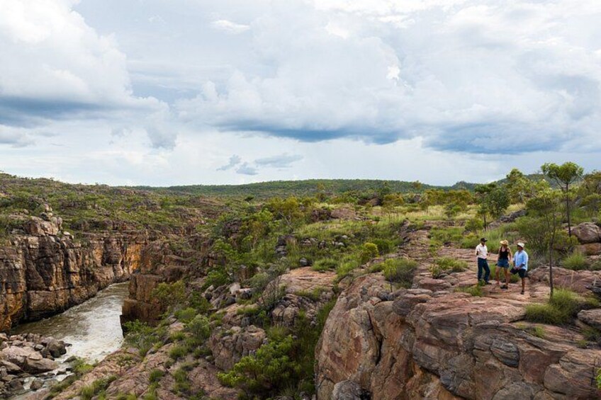 A canyon with a river, rocky terrain, and sparse vegetation. 3