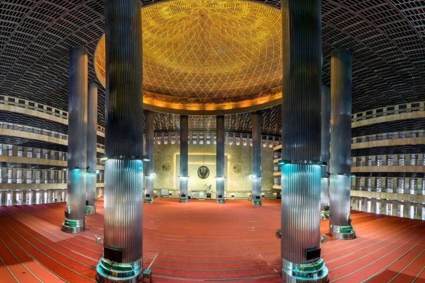 A large hall with a domed ceiling, tall columns, and a red carpet. 4