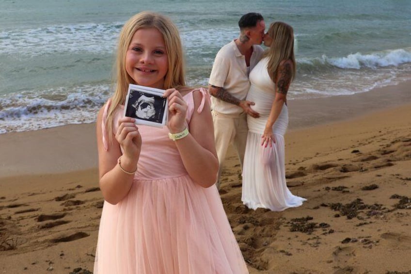 A beach scene with a person holding a photo, a couple embracing, and a pregnant woman in the background. 4