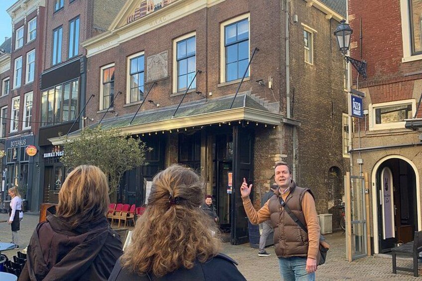 A street scene with a pub named 'The Butchers Arms' and a person gesturing. 4
