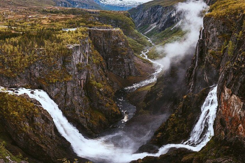 A canyon with waterfalls and a river. 2