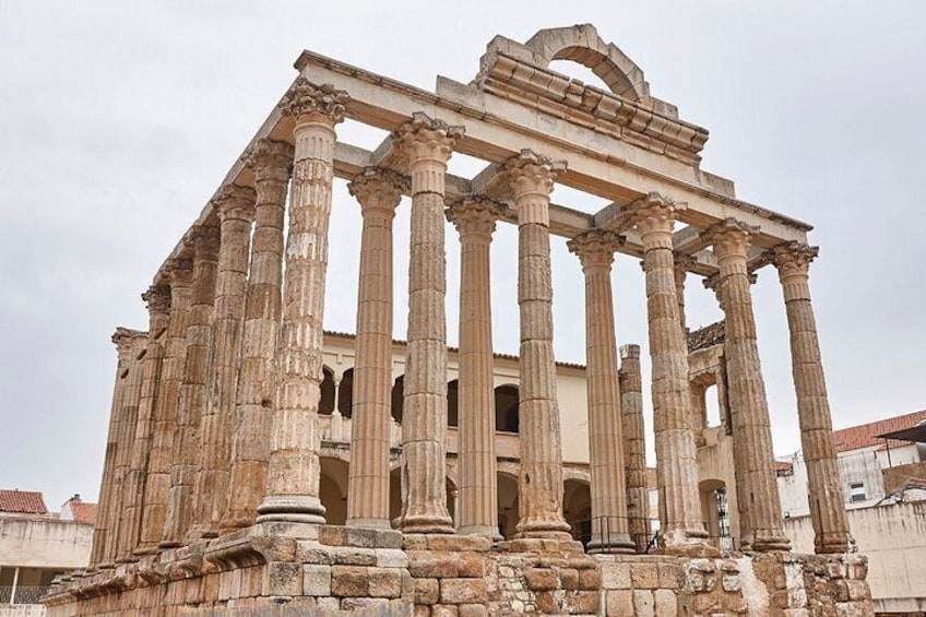 An ancient Greek temple with multiple columns and a partially intact roof structure. 3