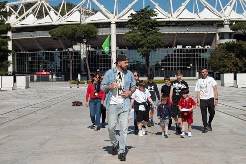 A group of people walking in front of a modern building with a unique architectural design. 4