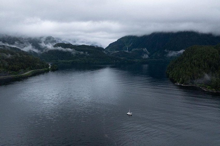 A lake surrounded by mountains with a small boat in the water. 5