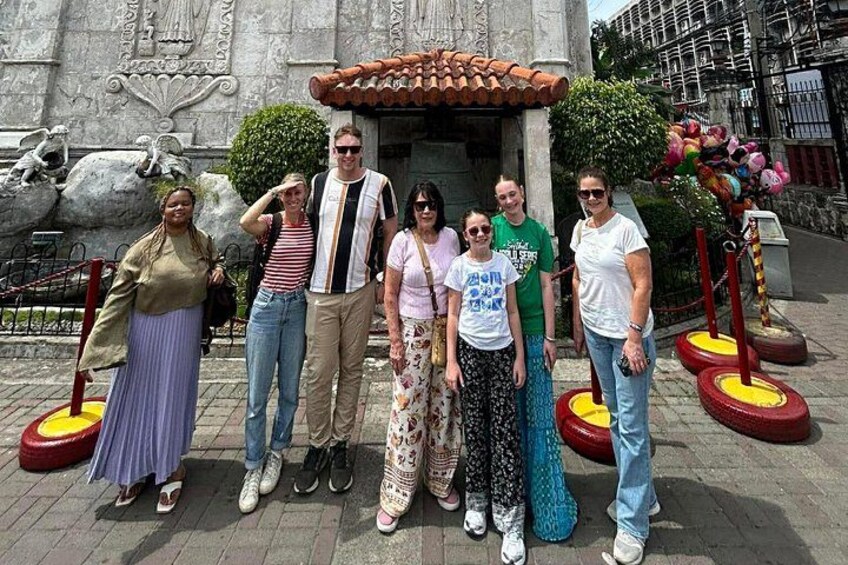 Un grupo de personas posando frente a un edificio histórico con elaborados adornos y techo de tejas. 5