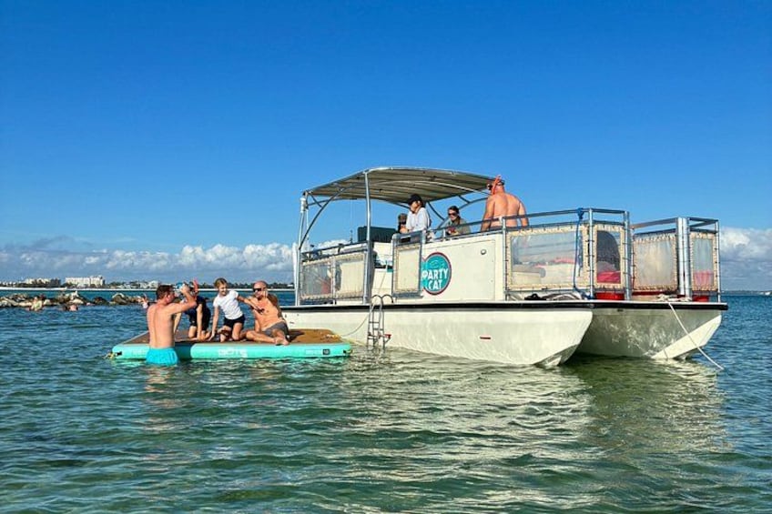 A boat with people on it, floating on water. 5