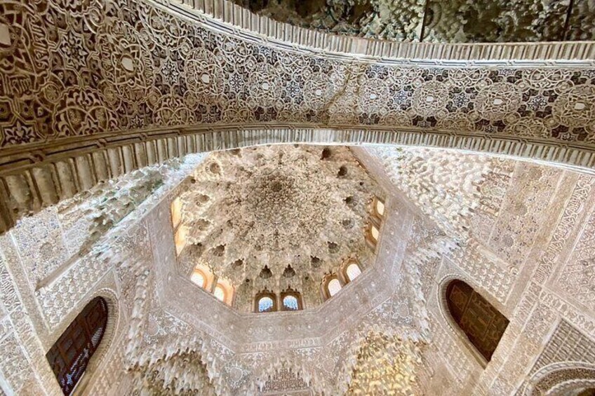 An ornate, intricately designed interior with a central dome and surrounding arches. 3