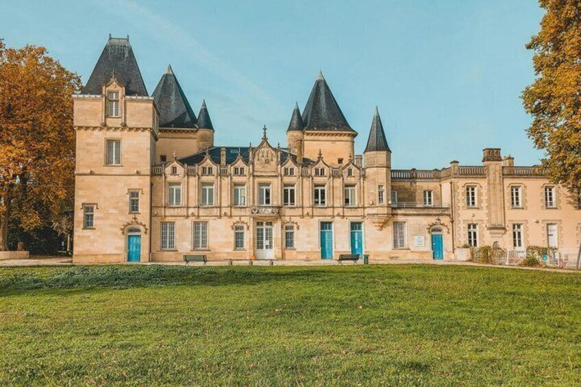 A historic building with multiple towers and blue doors. 5