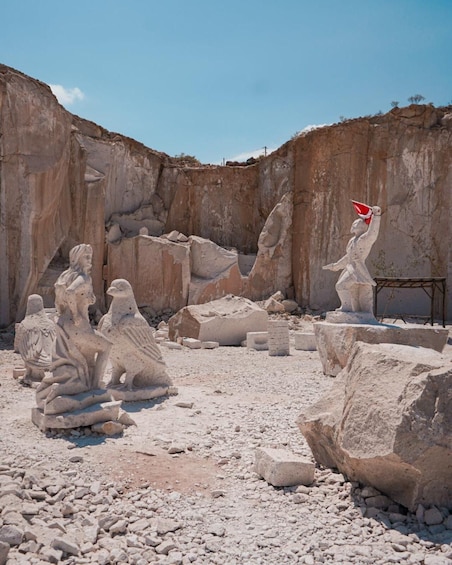 Ancient stone sculptures in a rocky excavation site. 2