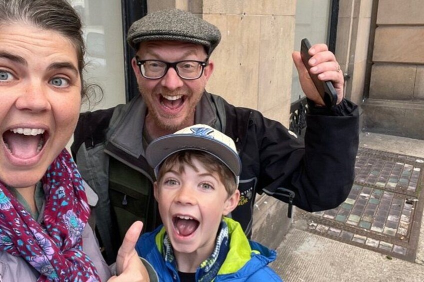 Three people in front of a building with a stone facade. 3
