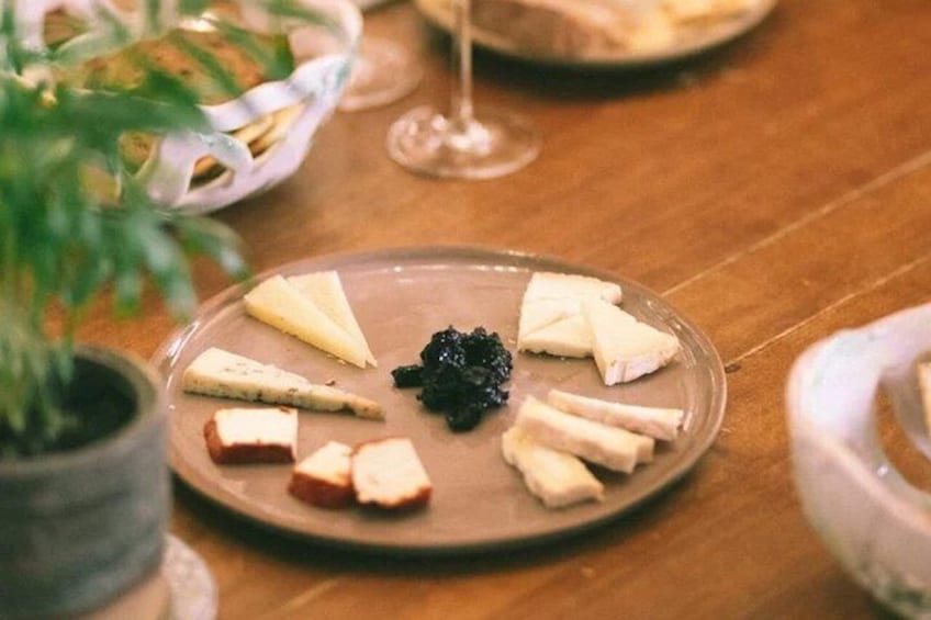 A plate of cheese and crackers on a wooden table. 1