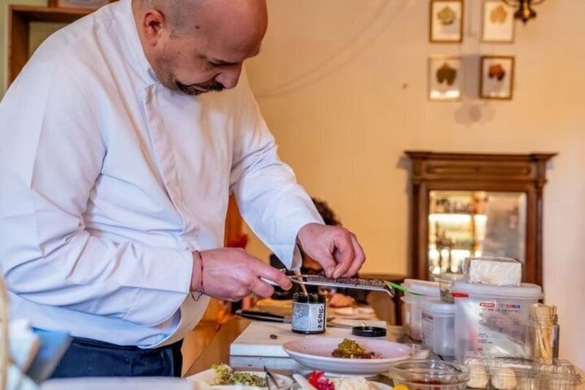 A chef preparing food in a kitchen. 4