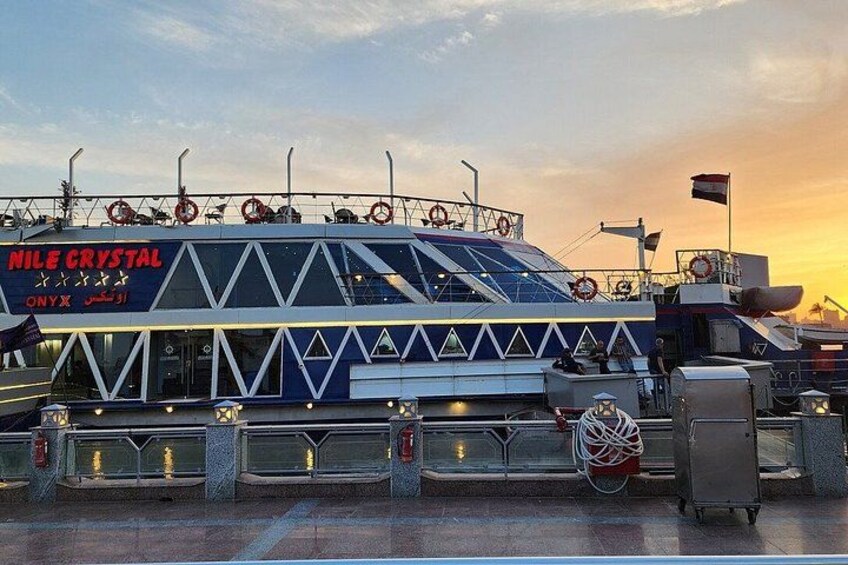 A large, uniquely designed ship named 'Nile Crystal' docked at a port. 5