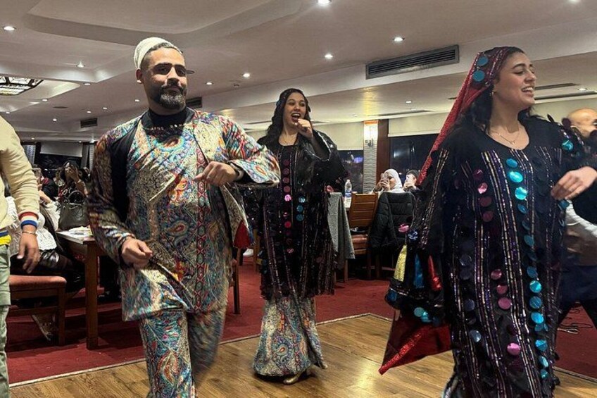 People in traditional attire, a wooden floor, and indoor lighting. 4