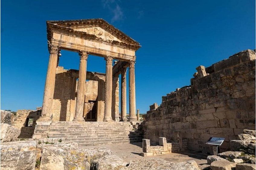 Ancient ruins with columns and a stone staircase. 2