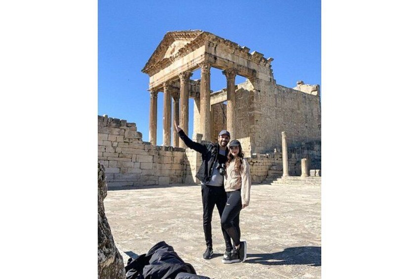 Ancient ruins with columns and a partially intact structure. 3