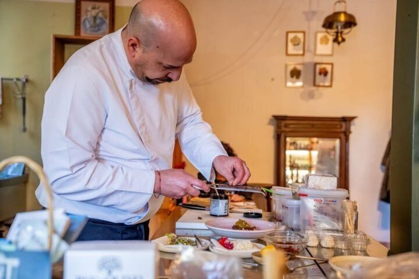 A chef preparing food in a kitchen. 5