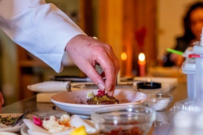 A person serving food on a plate. 4