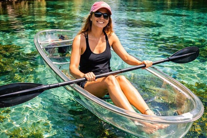 A person kayaking in clear water. 1
