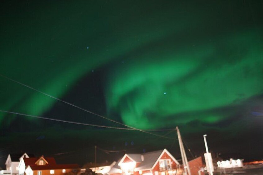 The Northern Lights over a residential area with houses and power lines. 5