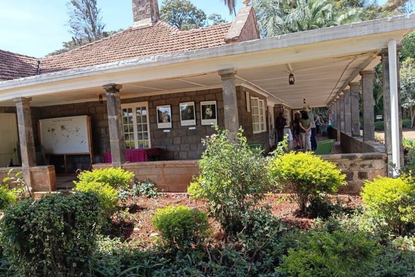 A covered outdoor area with stone columns, a tiled roof, and framed pictures on the wall. 5