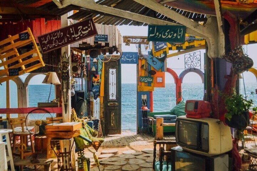 A colorful outdoor market with various stalls and items for sale. 4