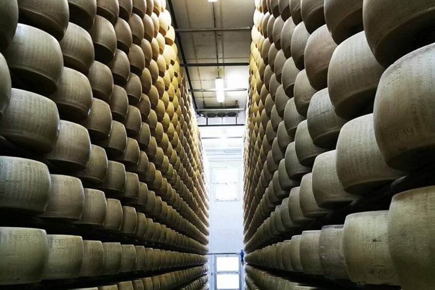 A warehouse with rows of large cylindrical objects, possibly storage containers or equipment, arranged in a grid pattern. 2
