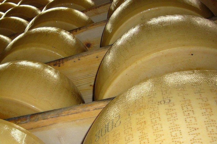 A collection of golden bowls with inscriptions, arranged in a wooden rack. 1