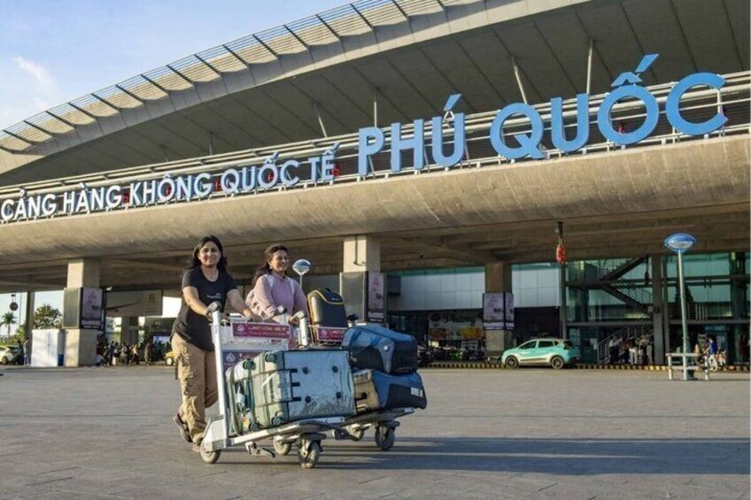 A luggage cart at an airport with a sign reading "CANG HANG KHONG QUOC PHU QUOC". 2