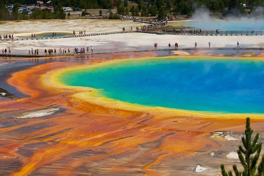 A geothermal hot spring with a curved shoreline and a viewing platform. 1