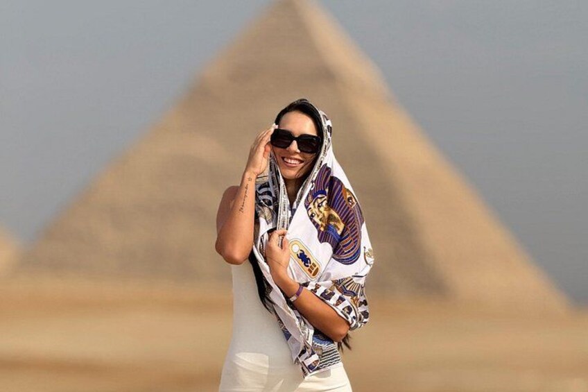 A person standing in front of the Great Pyramid of Giza. 2