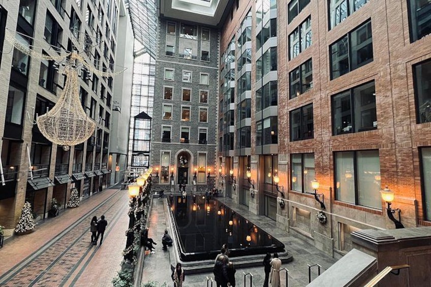 A modern building with a central courtyard, large windows, and decorative lighting. 5