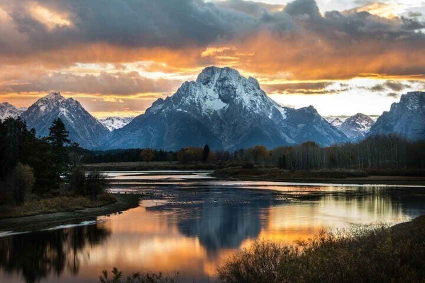 A mountain range with a lake reflecting the peaks. 3