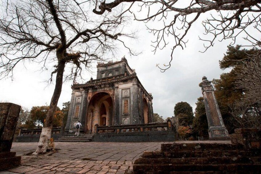 An ancient gate with intricate carvings and a stone pathway leading up to it. 5