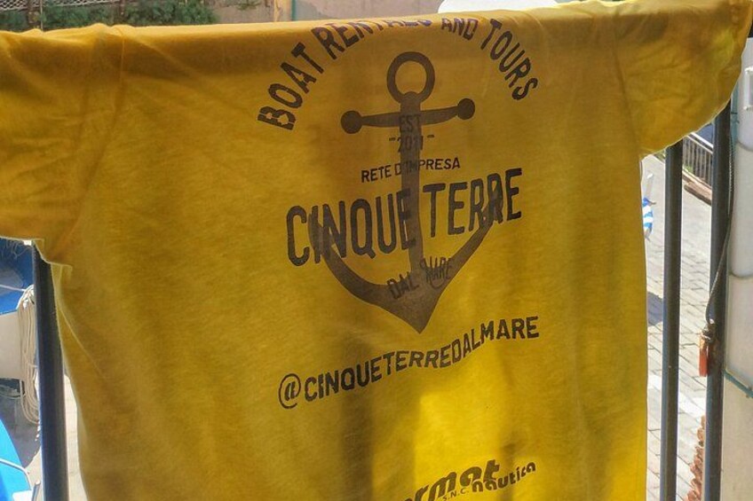 A yellow t-shirt with text and graphics. 4