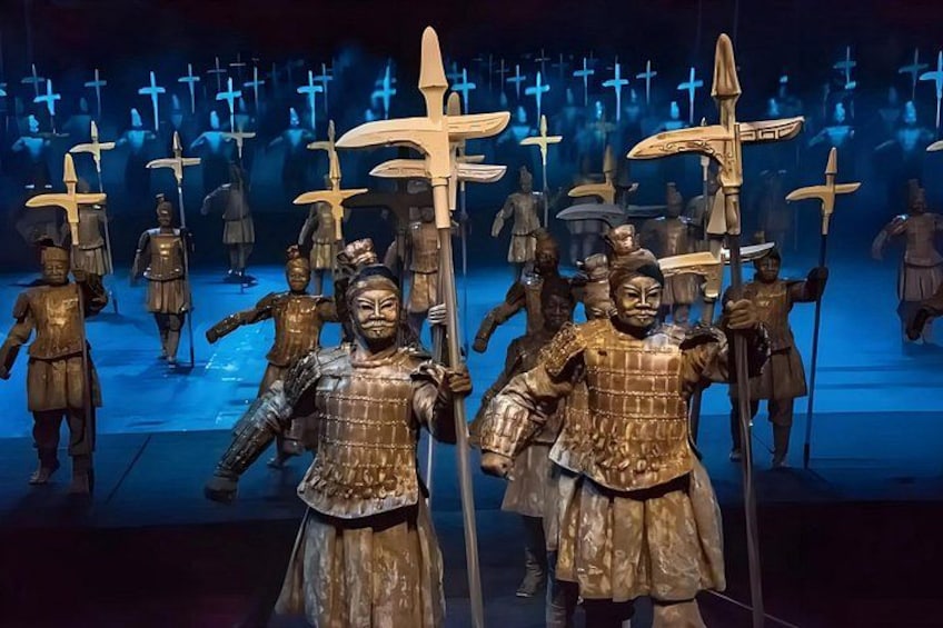 A group of bronze statues in ancient warrior attire, some holding spears, set against a backdrop of crosses. 4