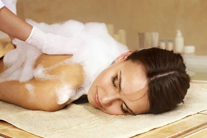 A person receiving a massage with foam on their back. 1