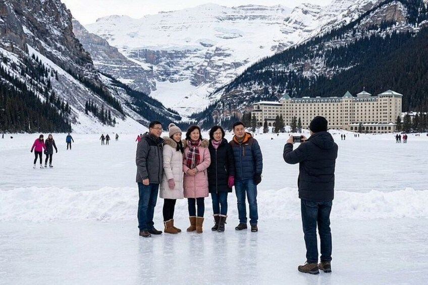 A group of people on a frozen lake with mountains in the background. 2