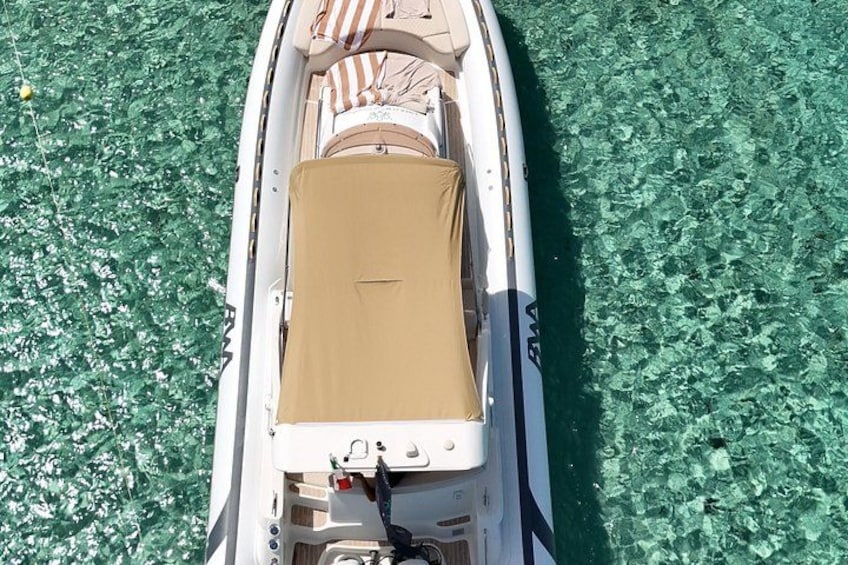 A boat with a brown cover, clear water, and a green aquatic environment. 4